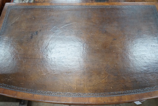 A Regency style mahogany bow front three drawer writing table, width 101cm, depth 61cm, height 76cm